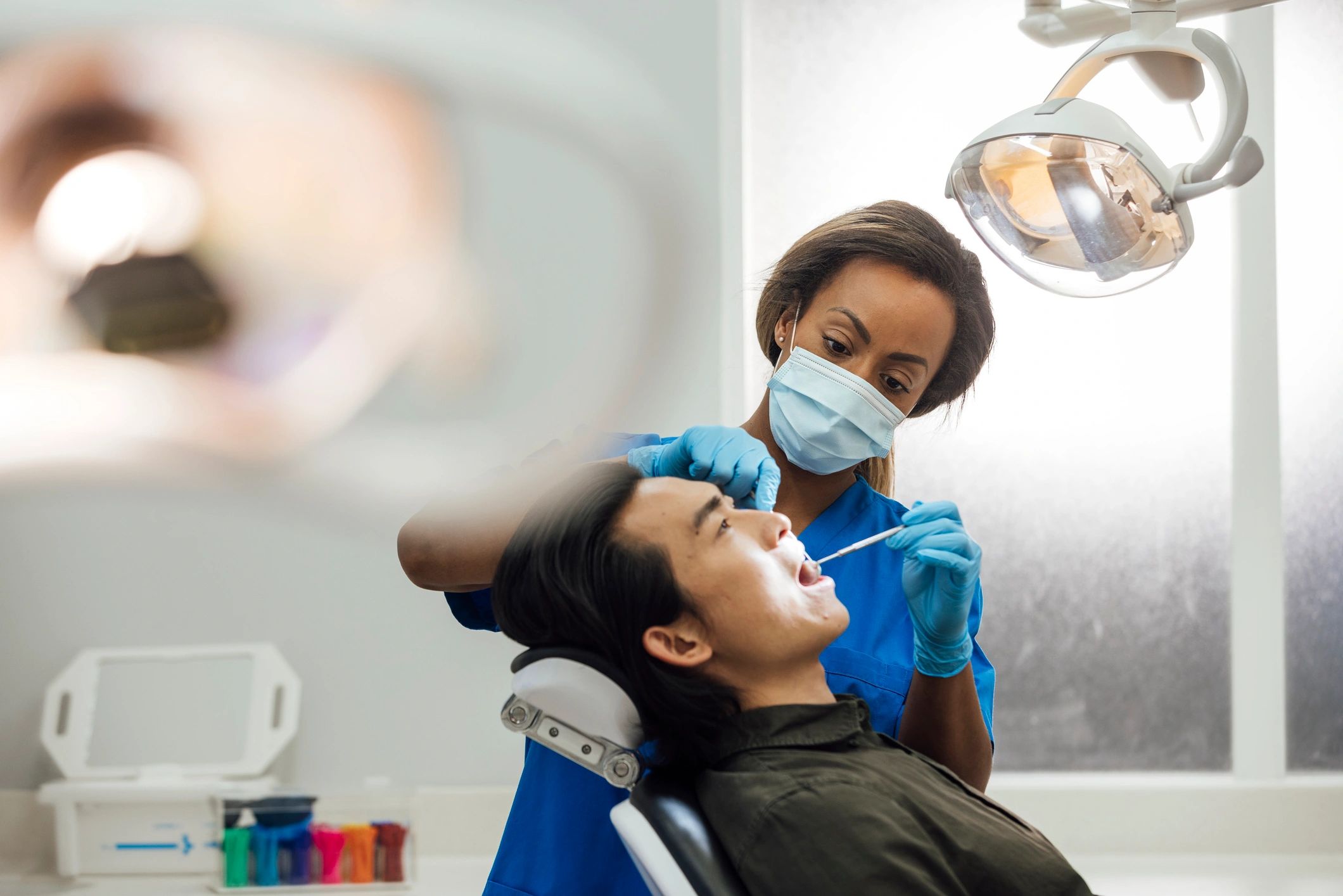 Dental checkup in progress with clinician examining a patient