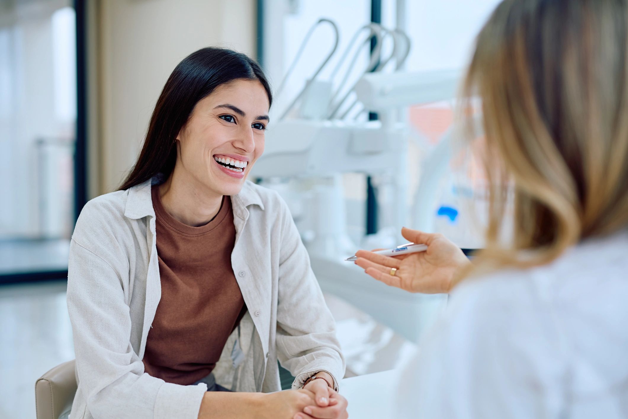 Patient consulting with a dentist in a modern dental office